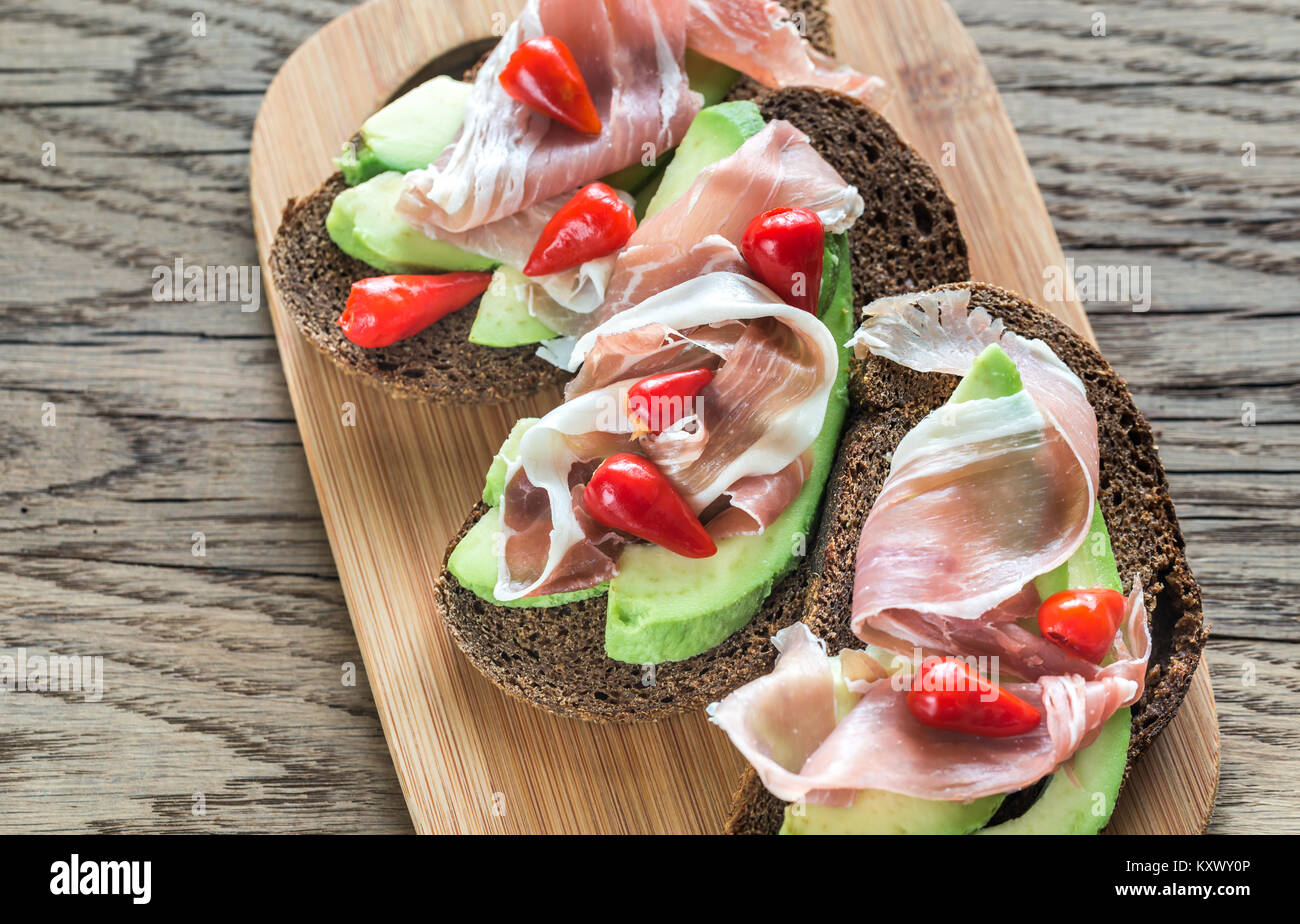 Sandwiches with avocado and prosciutto Stock Photo Alamy