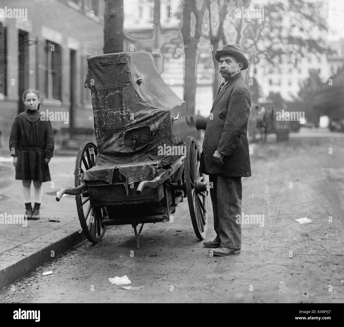 Italian Organ Grinder Has his Instrument covered with Tarp Stock Photo