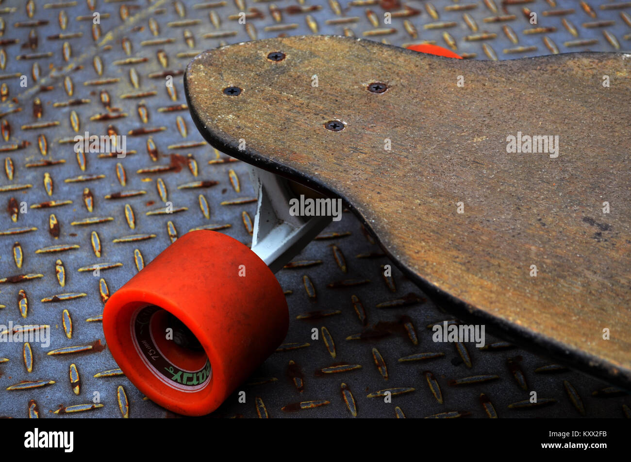 Longboard skateboard on metal backdrop Stock Photo
