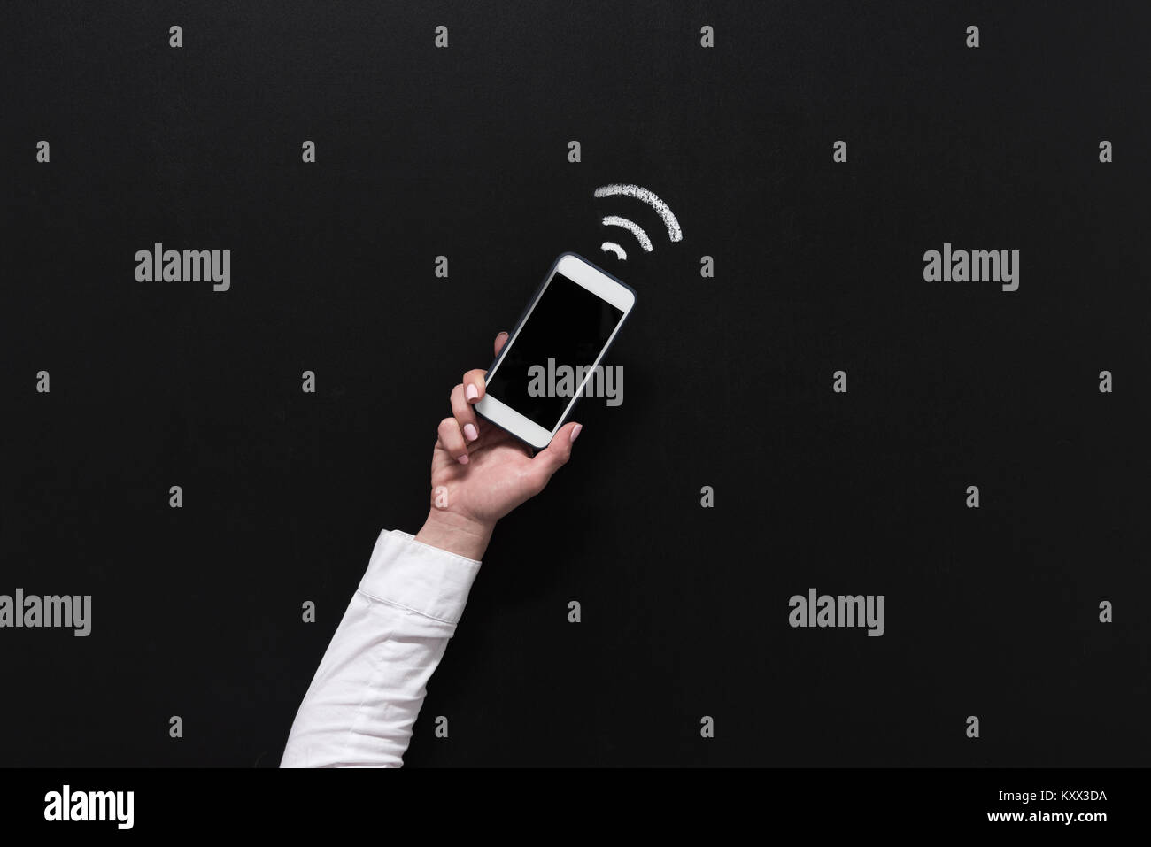 hand of woman holding smartphone with blank screen isolated on black ...