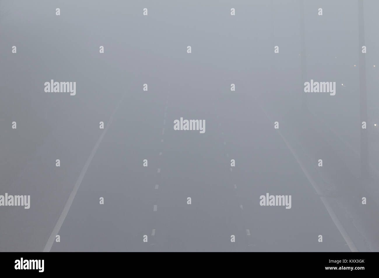 car driving on motorway without lights (right lane halfway up photo) on