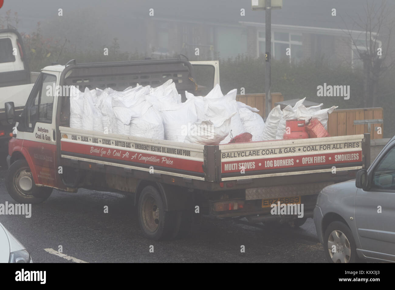 van delivering coal and solid fuel on a foggy day in the uk Stock Photo