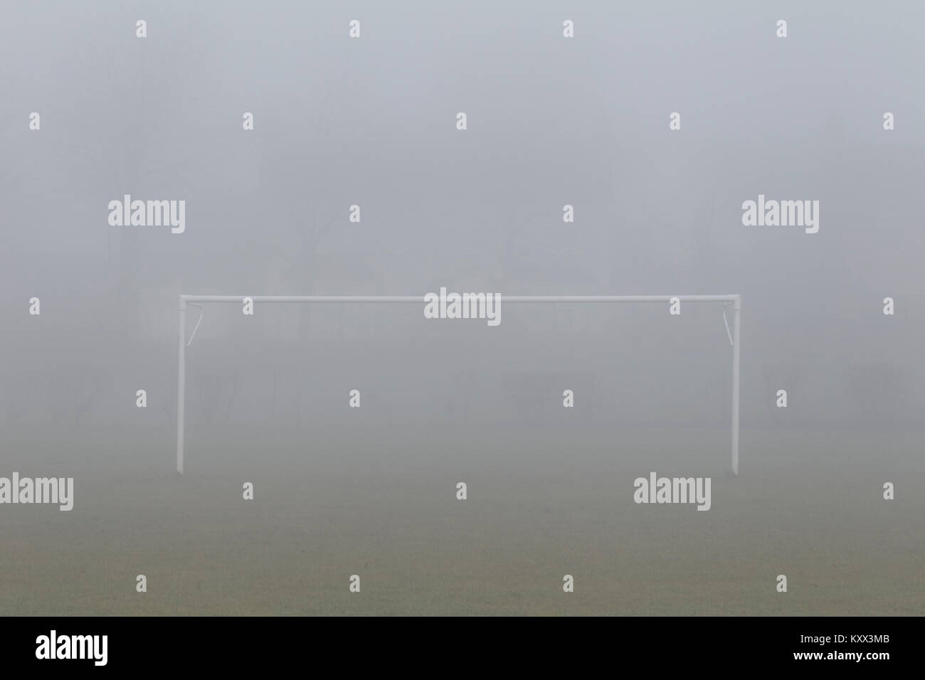 football soccer goalposts on a pitch in a foggy day in the uk Stock Photo