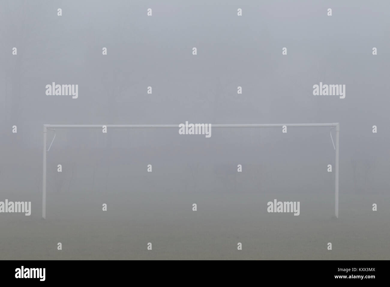 football soccer goalposts on a pitch in a foggy day in the uk Stock Photo