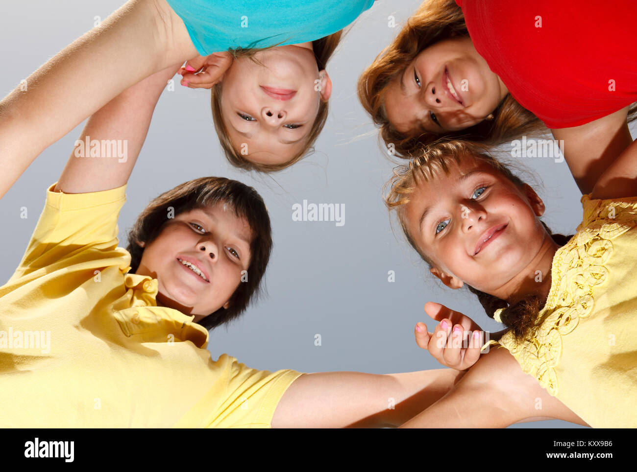 Group of four happy children showing unity Stock Photo