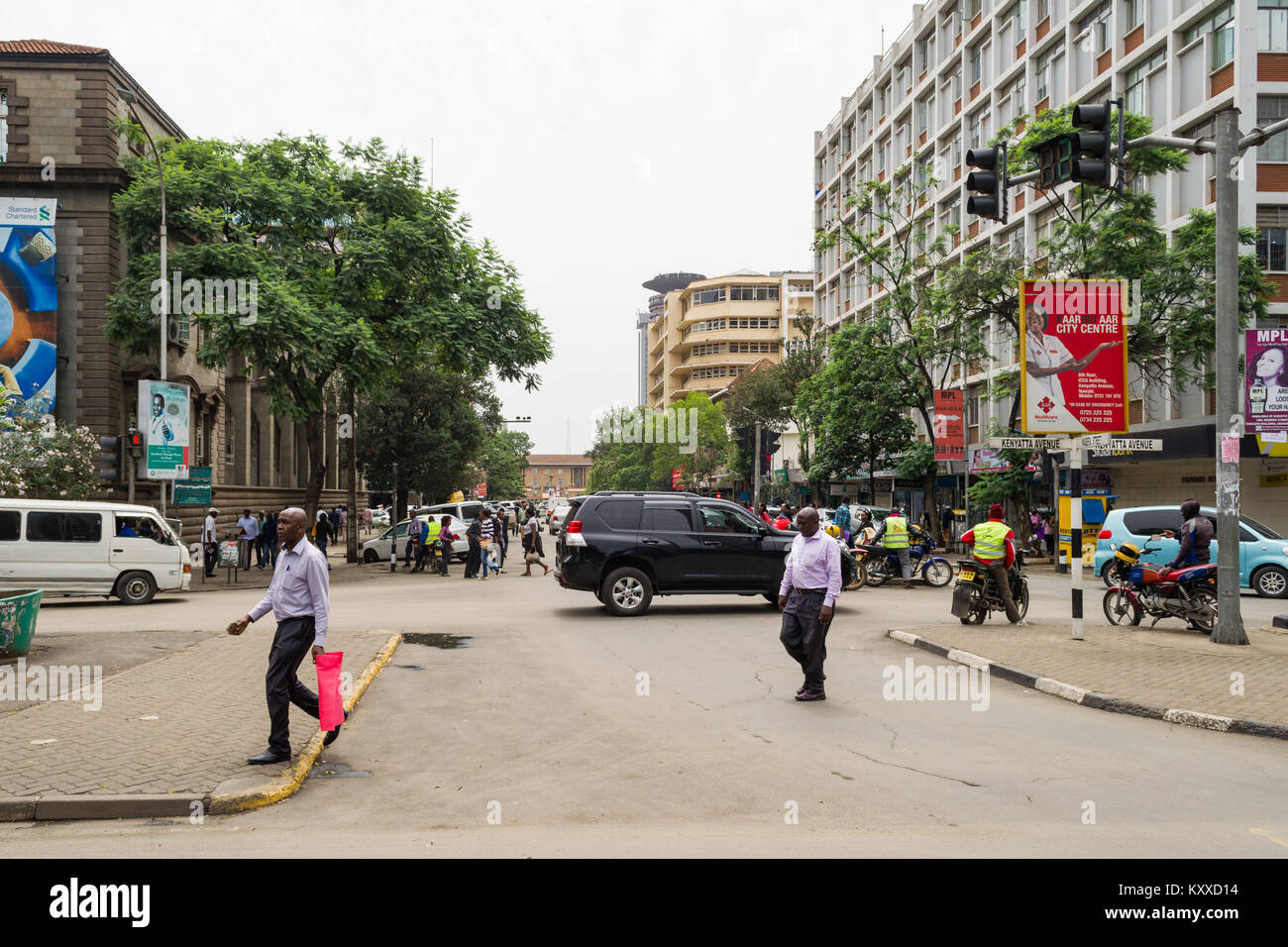 View down Wabera Street towards Kenyatta International Conference Centre with people going about daily life, Nairobi, Kenya Stock Photo