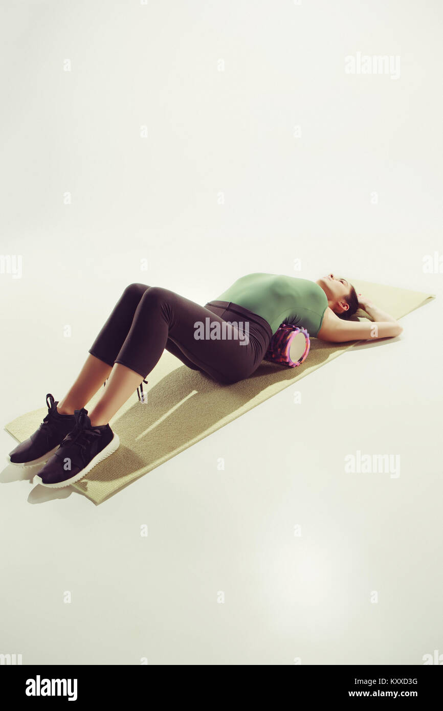 Front view of a young woman stretching body in gymnastics class Stock ...