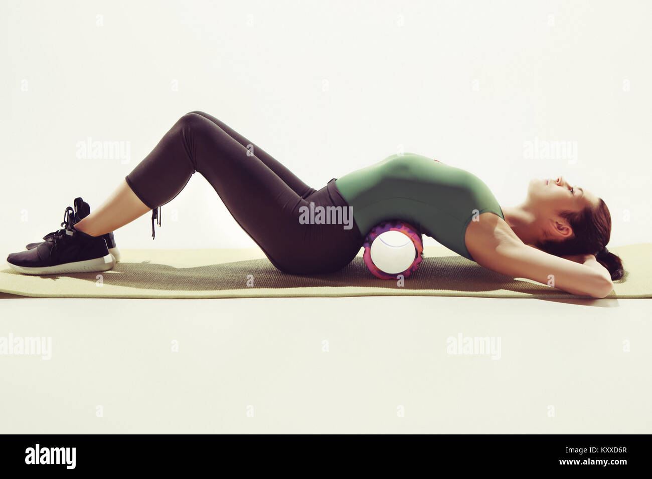 Front view of a young woman stretching body in gymnastics class Stock ...