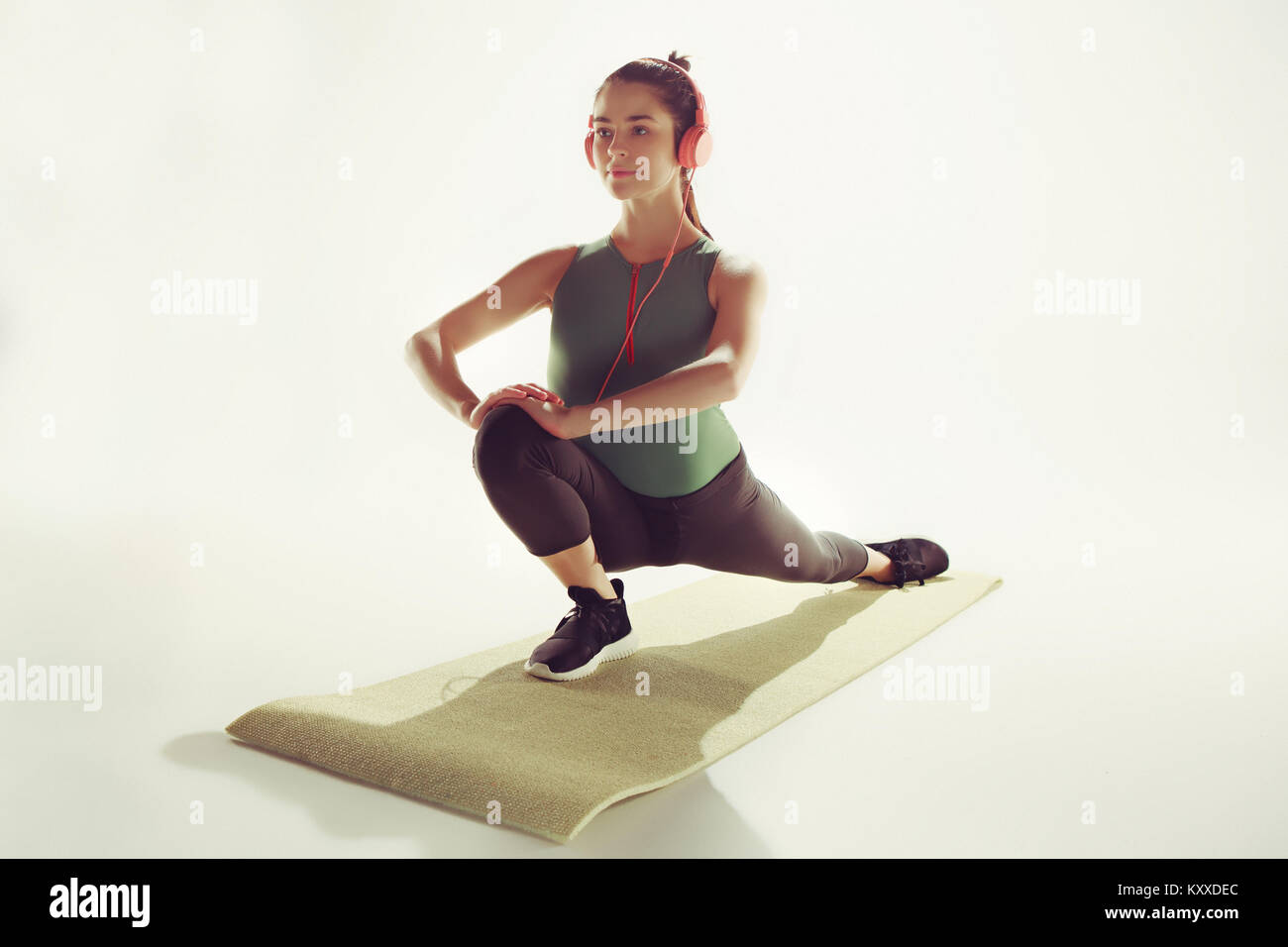 Front view of a young woman stretching body in gymnastics class Stock ...