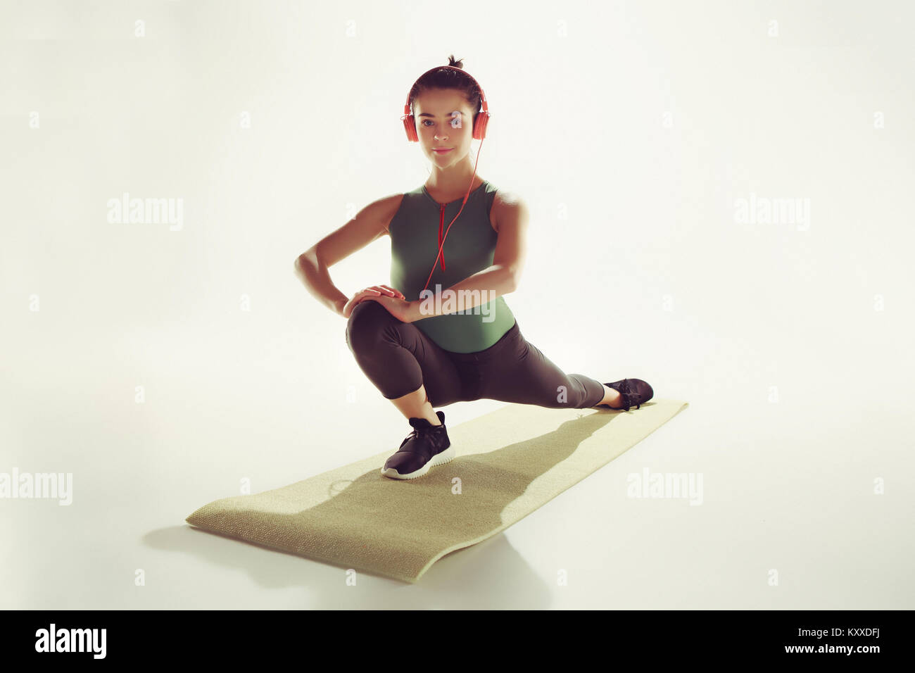Front view of a young woman stretching body in gymnastics class Stock ...