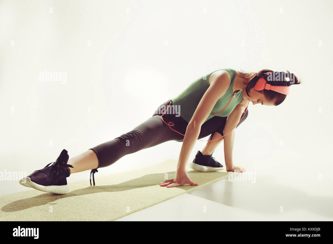 Front view of a young woman stretching body in gymnastics class Stock ...