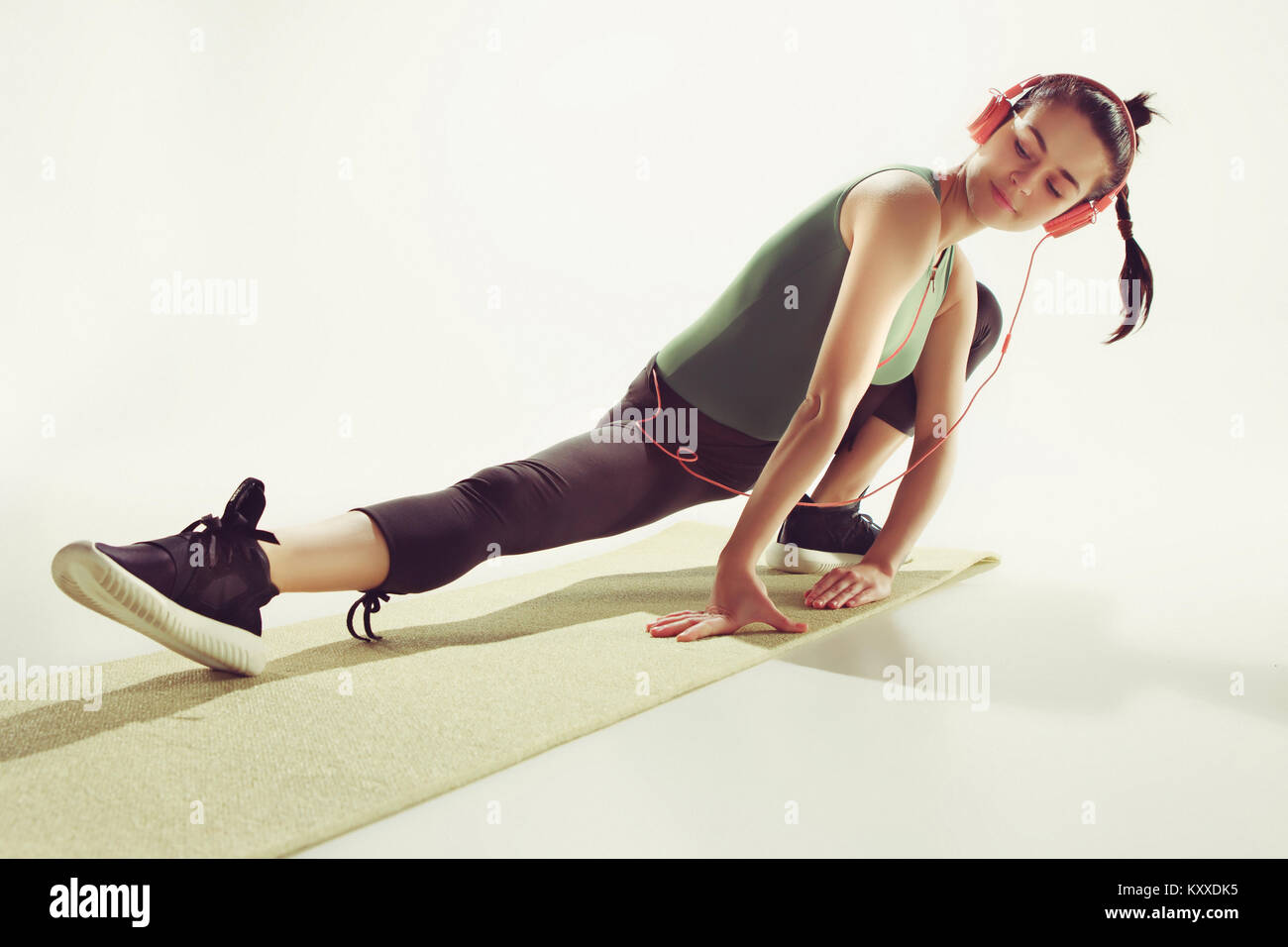 Front view of a young woman stretching body in gymnastics class Stock ...