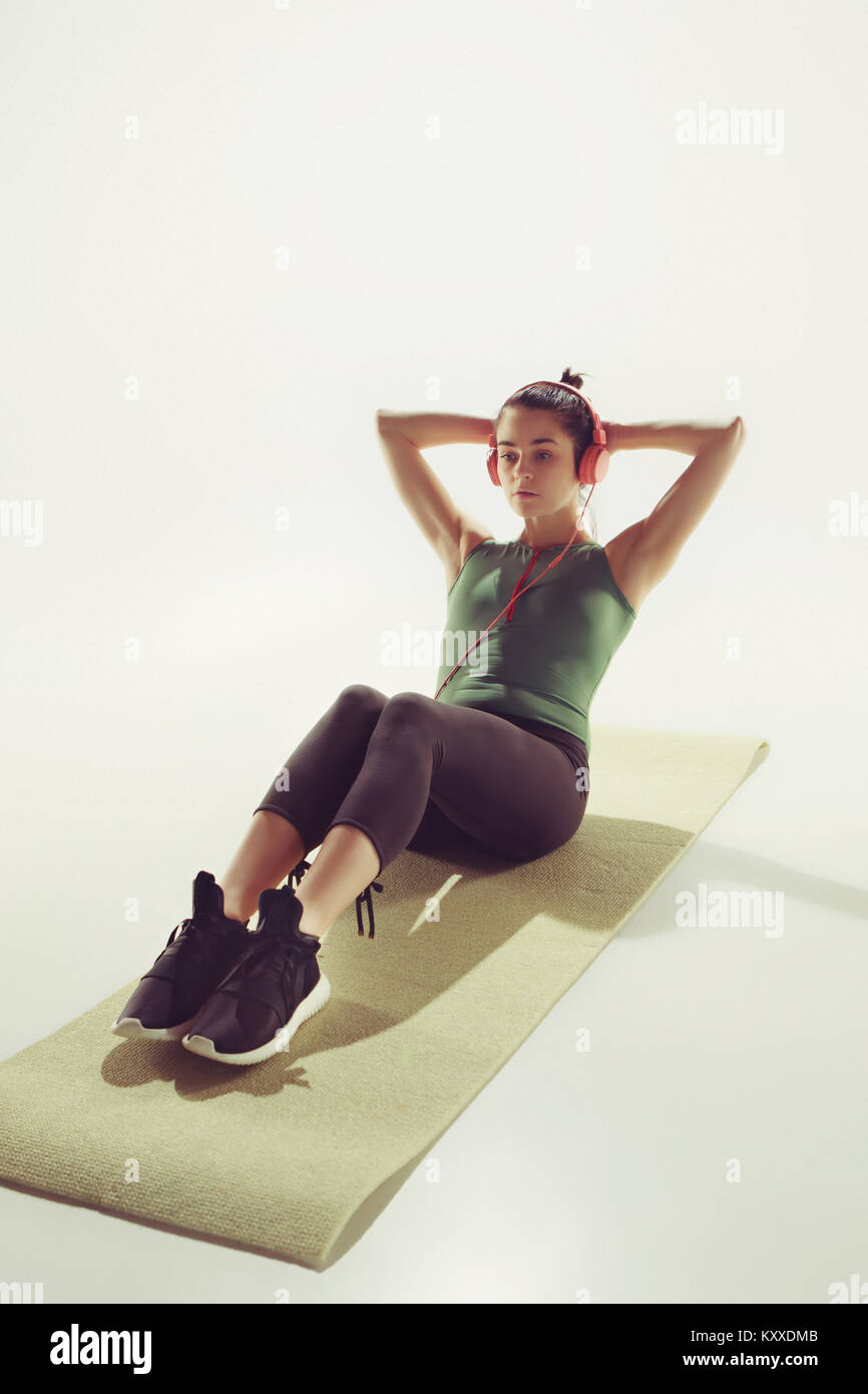 Front view of a young woman stretching body in gymnastics class Stock ...