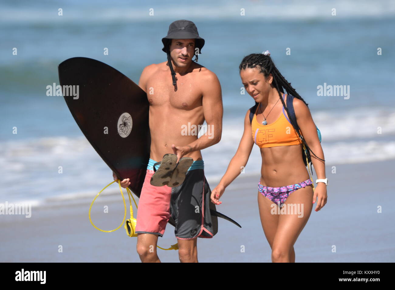 man and woman chat on beautiful beach after surfing Costa Rica lifestyle Stock Photo