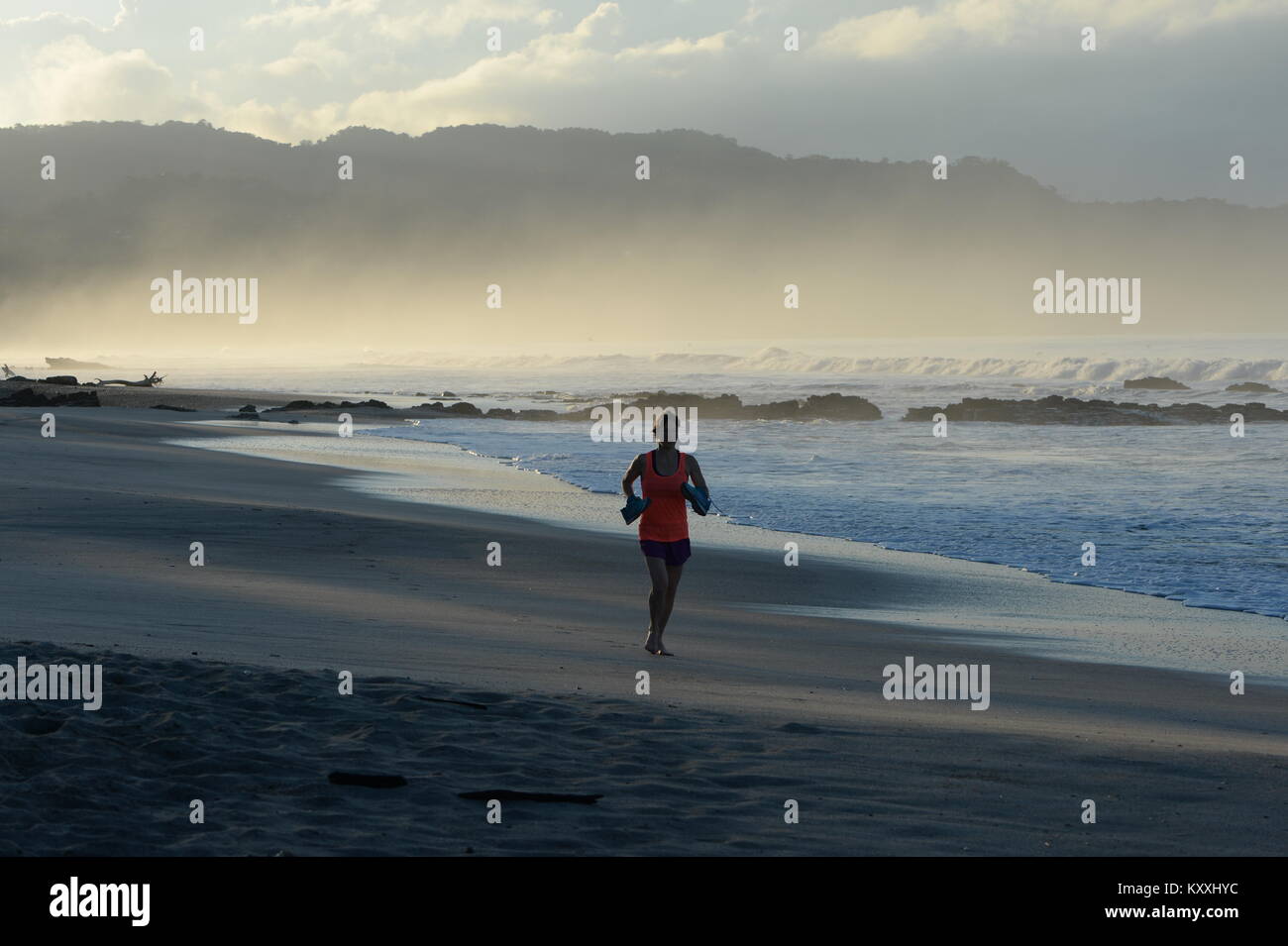 Running at dawn on a deserted beach, Costa Rica lifestyle Stock Photo