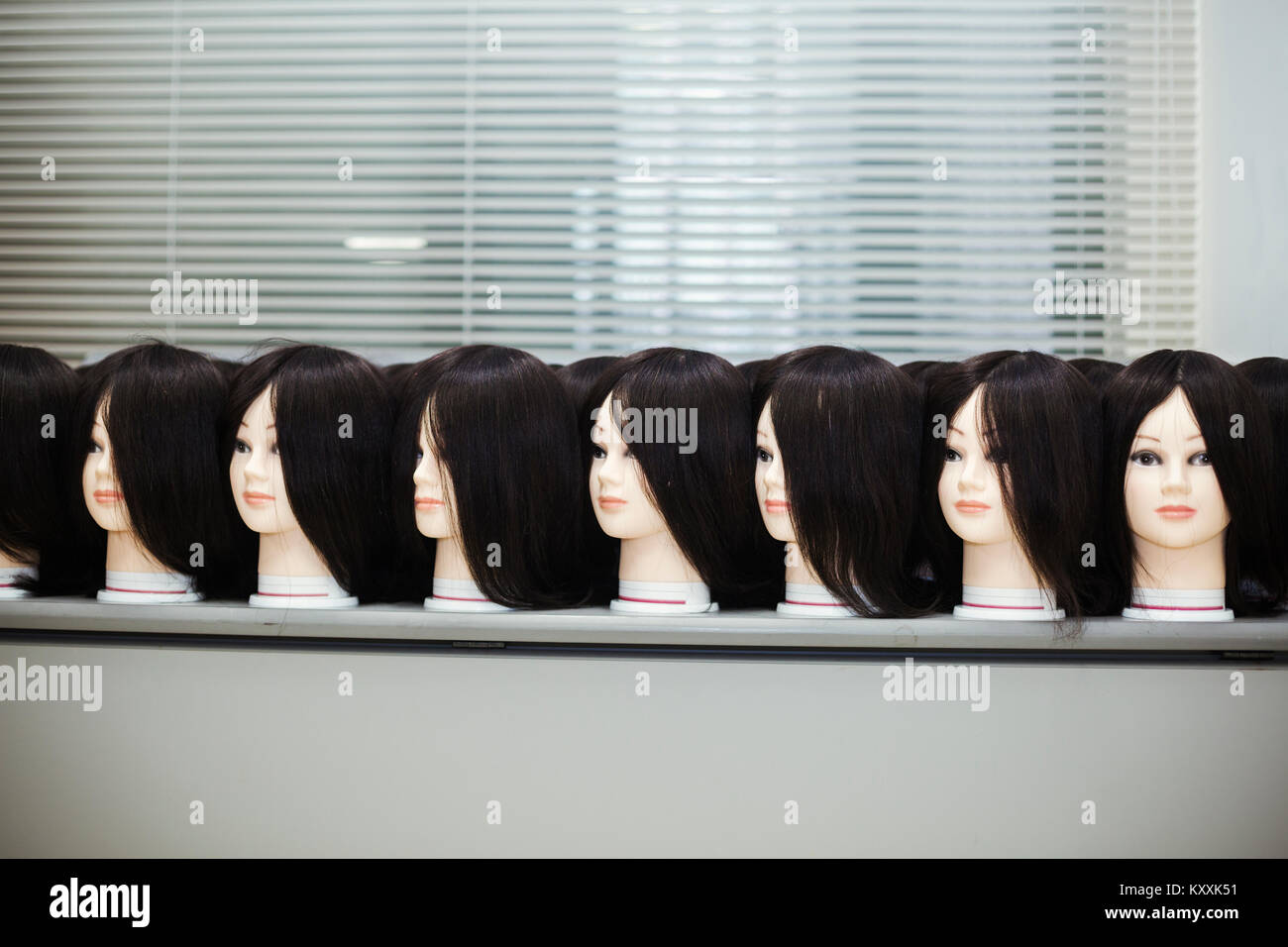 Rows of female wigs on mannequin heads in a shop window Stock Photo - Alamy