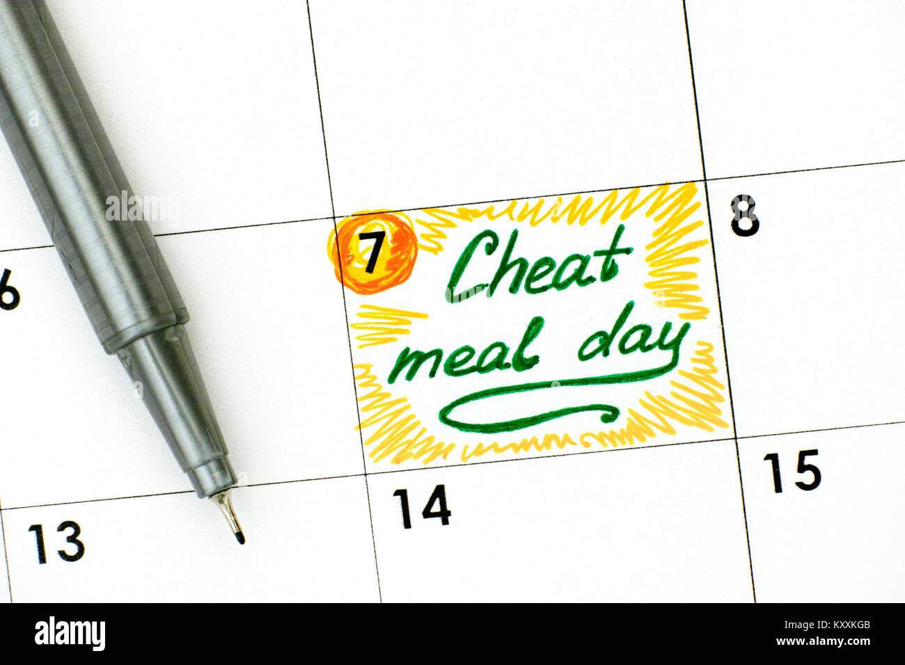 Reminder Cheat Meal Day in calendar with green pen. Close-up. Stock Photo