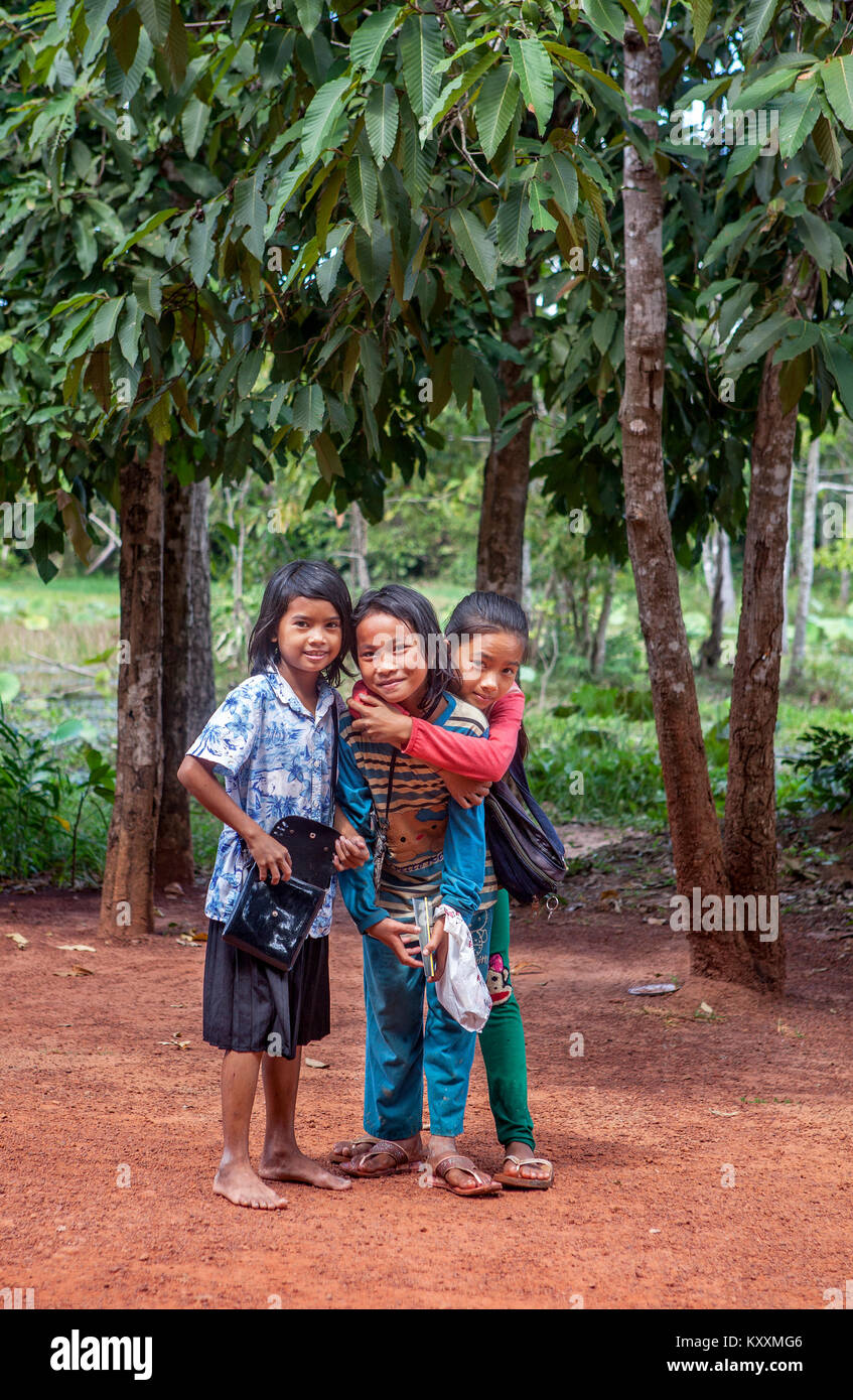 Three happy Cambodian Khmer schoolgirls on their way to school in  Banteay Srei, Kingdom of Cambodia. Stock Photo