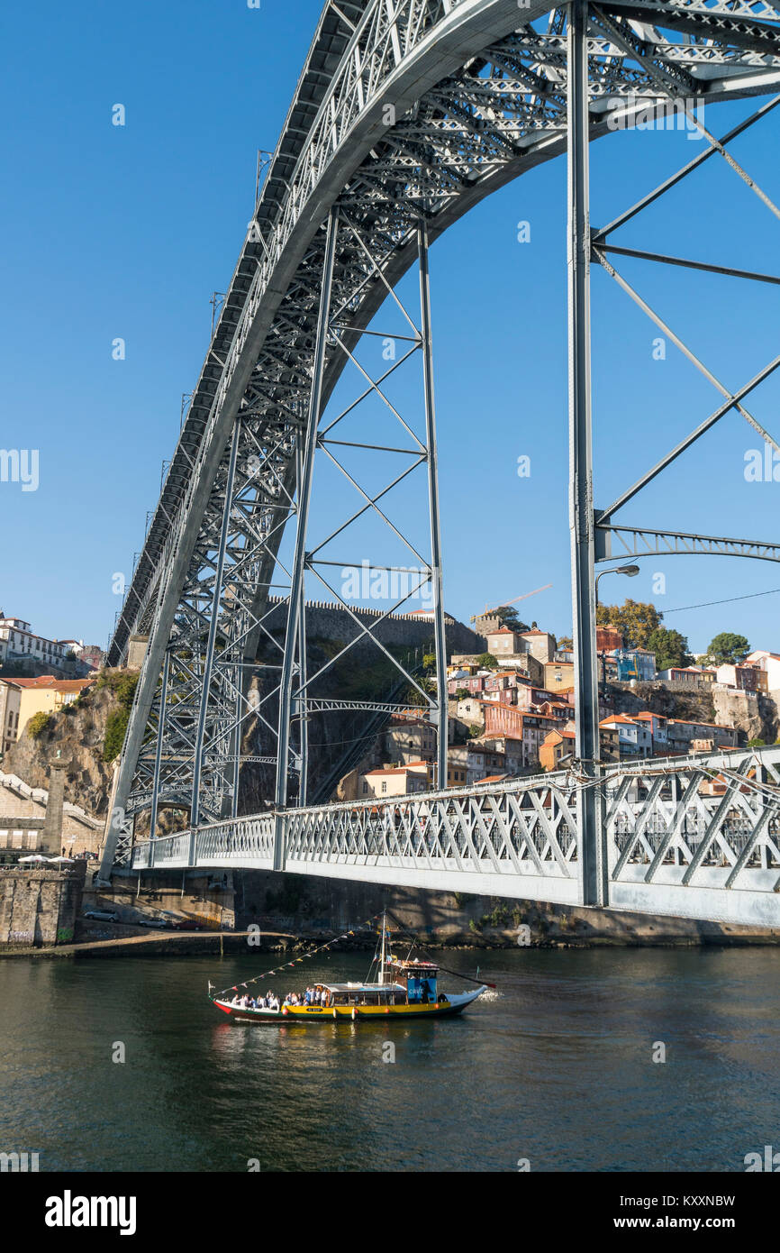 the River Douro waterfront looking towards the Ribeira district of Porto, Portugal. with the Dom Luis I Bridge in the foreground. Stock Photo