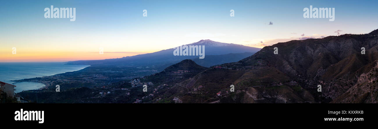 Sunset over the volcano Mount Etna and the gulf of Catania viewed from Taormina, Sicily, Italy, Europe Stock Photo