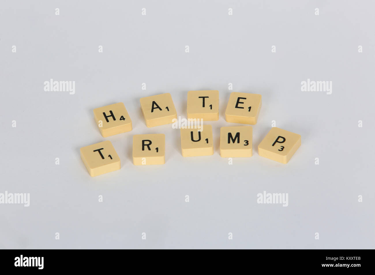Old Scrabble letters spelling out 'Love Trump' and 'Hate Trump' on a white background, London, UK. Stock Photo
