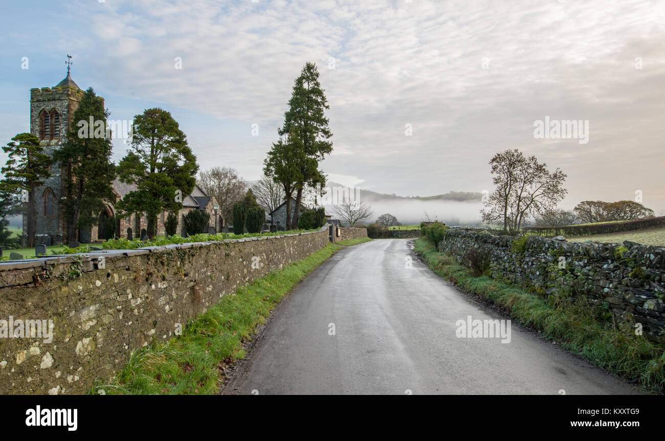 The road past Lowick Church on a misty November morning. Stock Photo