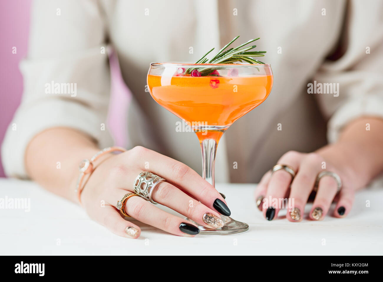 The rose exotic cocktails and fruits and female hand Stock Photo
