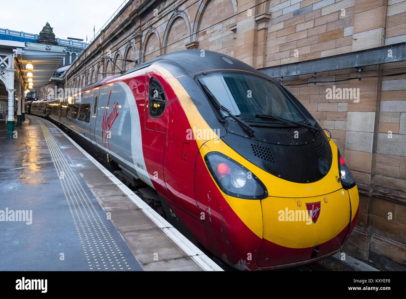 Virgin Trains Pendolino locomotive to London Euston  on West Coast Main line  at platform at Waverley Station in Edinburgh, Scotland, United Kingdom Stock Photo