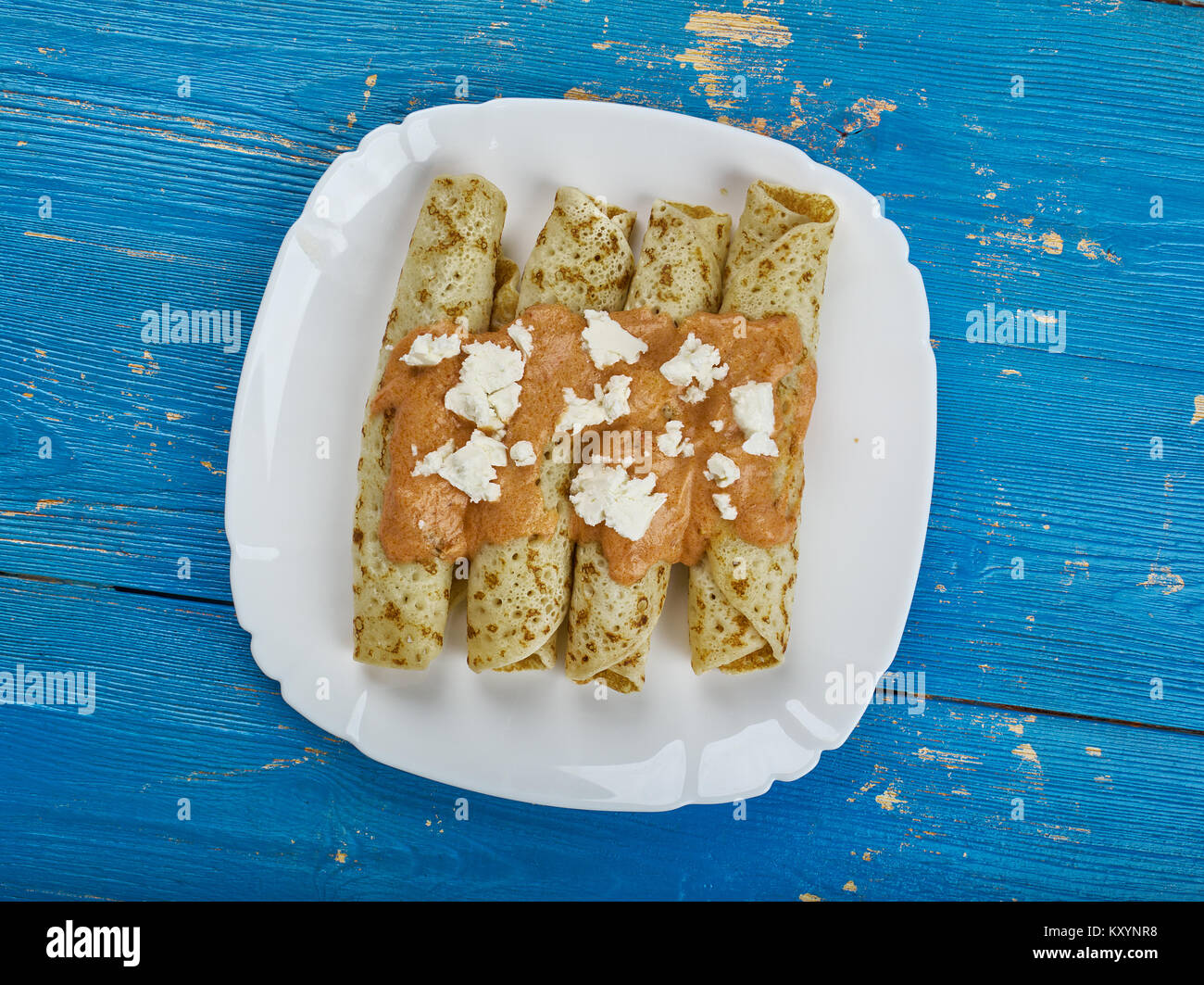 Entomatada typical Mexican dish made of a folded corn tortilla which