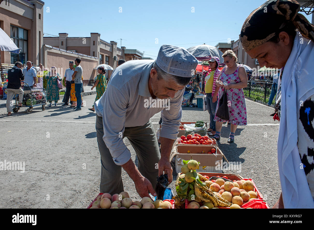 Man sells vegetable at the Siyob Bazaar, Samarkand, Uzbekistan Stock Photo