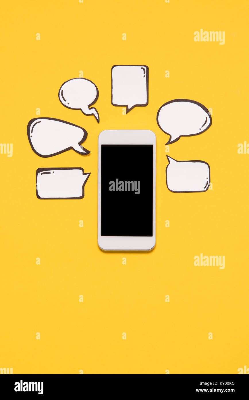 Close-up view of smartphone with black screen and blank speech bubbles ...
