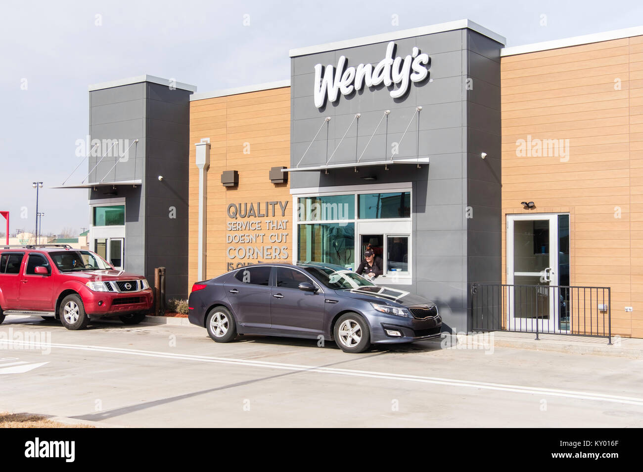 A line of customers in autos lined up at the takeout window at the opening of a new Wendy's restaurant. Oklahoma City, Oklahoma, USA. Stock Photo