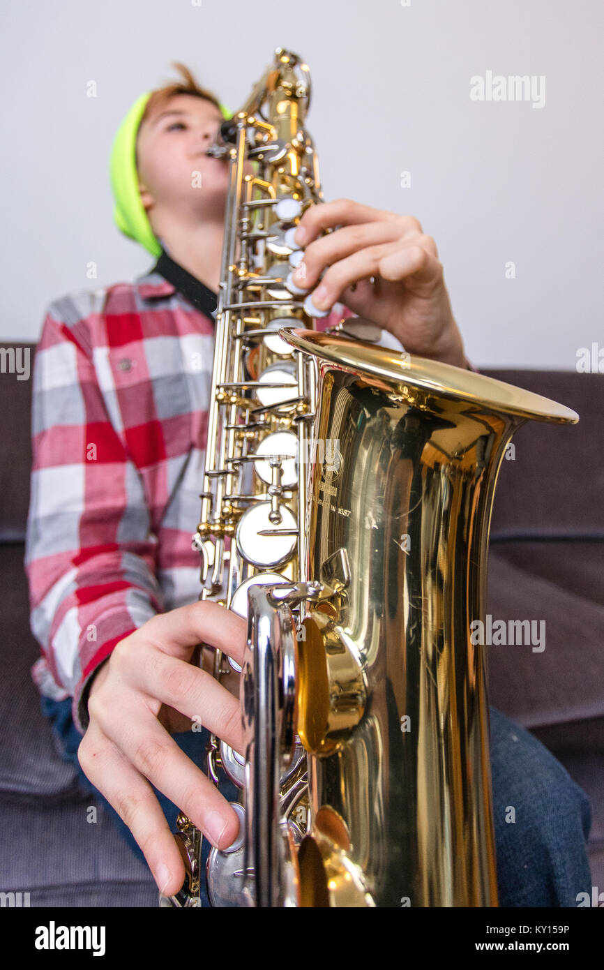 ELEVEN YEAR OLD CAUCASIAN BOY IN YELLOW TOQUE AND PLAID SHIRT PLAYS ...