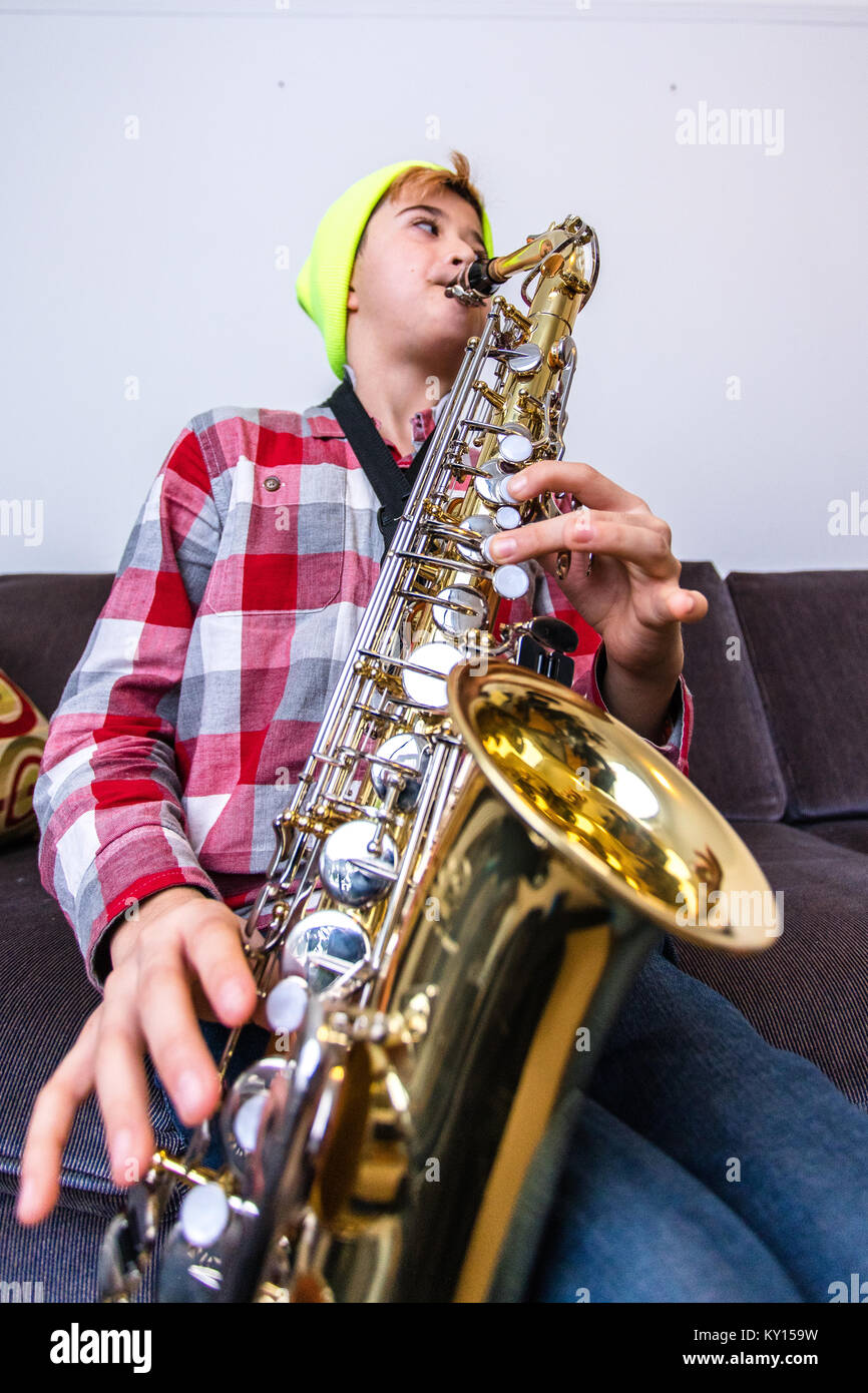 ELEVEN YEAR OLD CAUCASIAN BOY IN YELLOW TOQUE AND PLAID SHIRT PLAYS ...