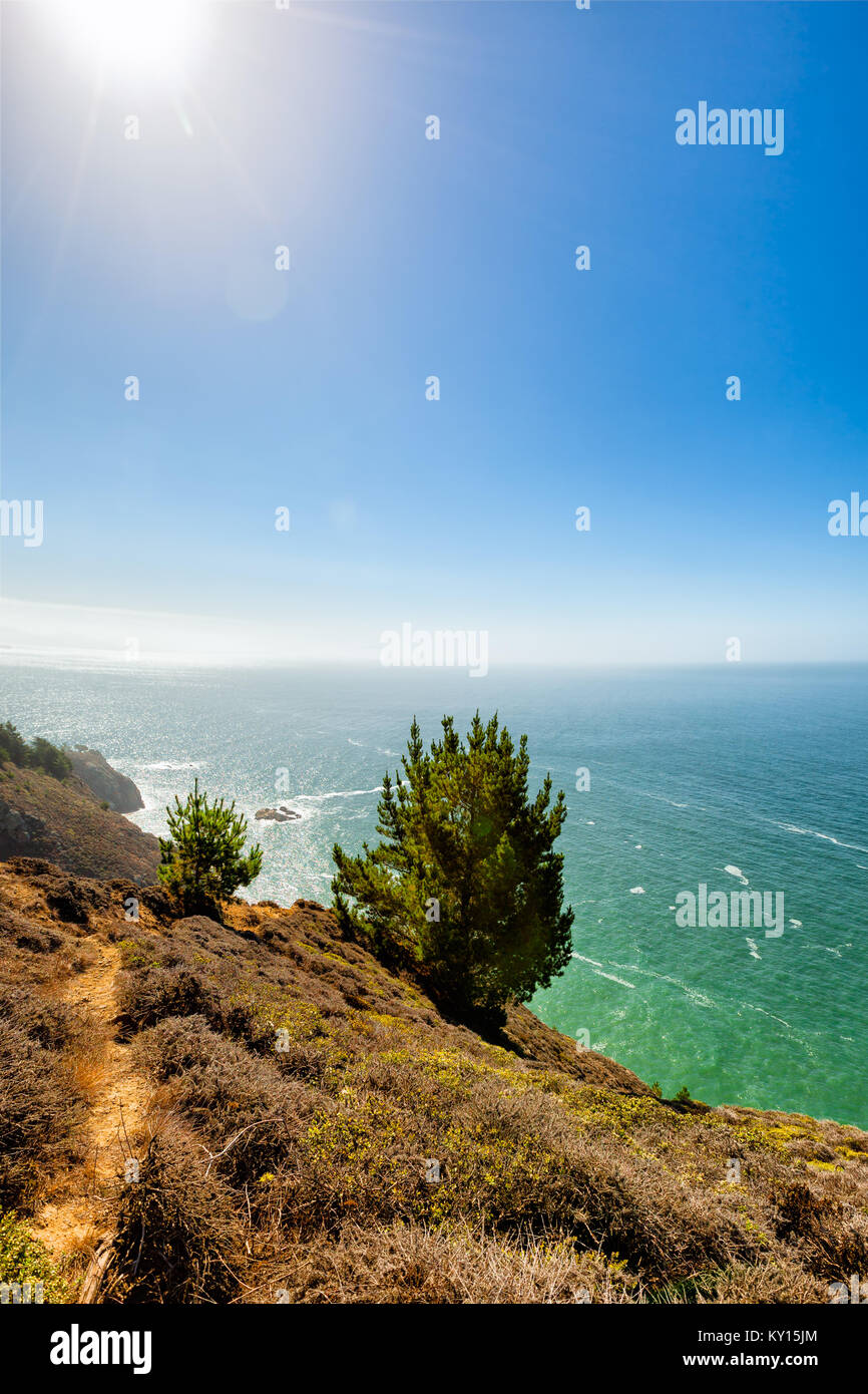 California seascape coastal trail with natural sun flare. Location: Muir Beach hills north of San Francisco Stock Photo