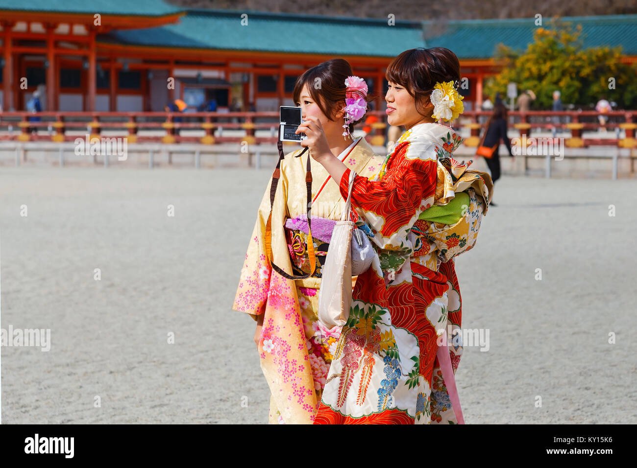JAPAN - NOVEMBER 22 2015: Beautiful Japanese ladies in traditional kimono dress at Heian-jingu shrine, kyoto Stock Photo