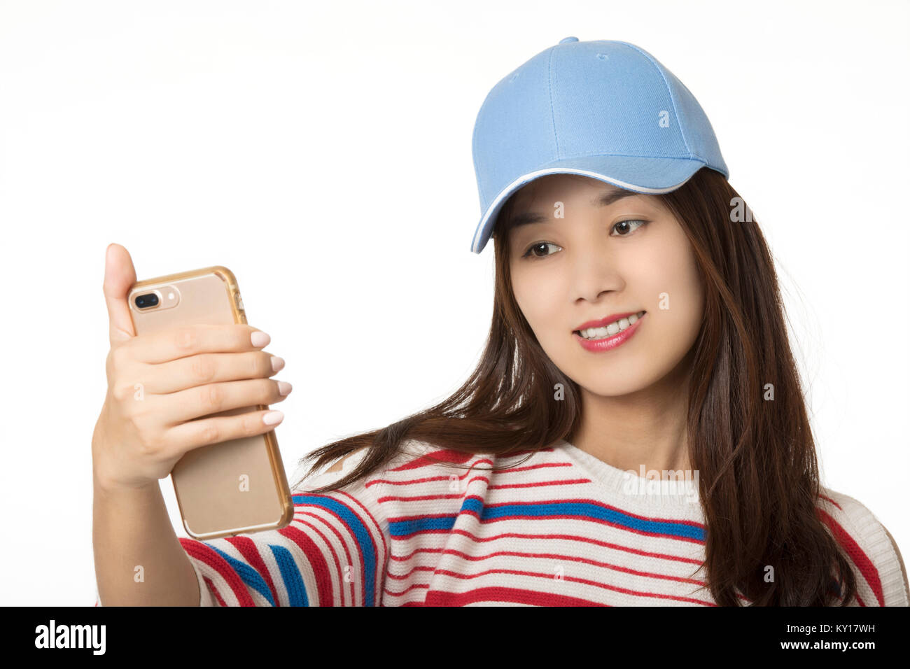 Asian American woman using a smartphone to take a selfie isolated on a white background Stock Photo