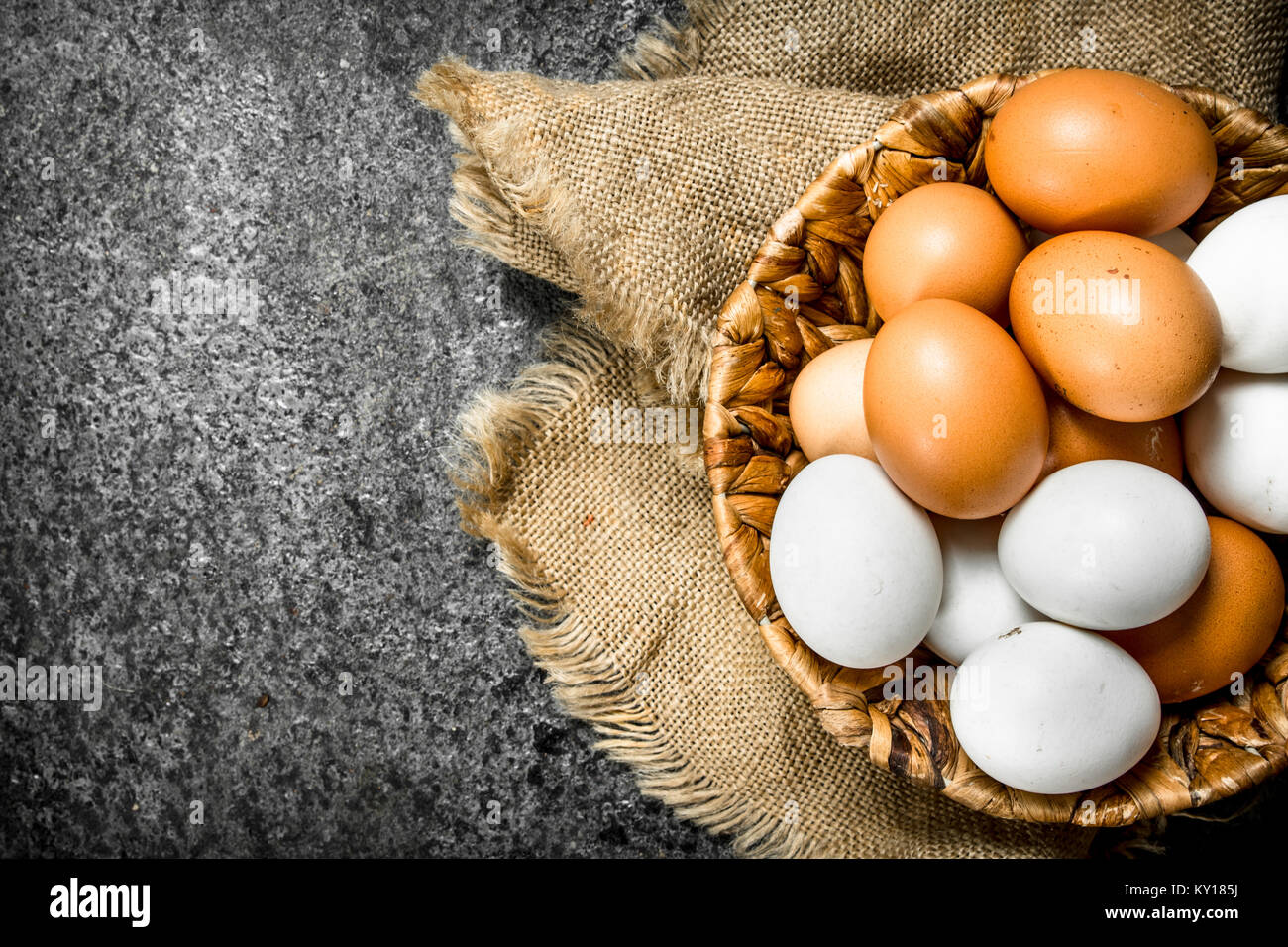Fresh eggs in the basket. On a rustic background Stock Photo - Alamy