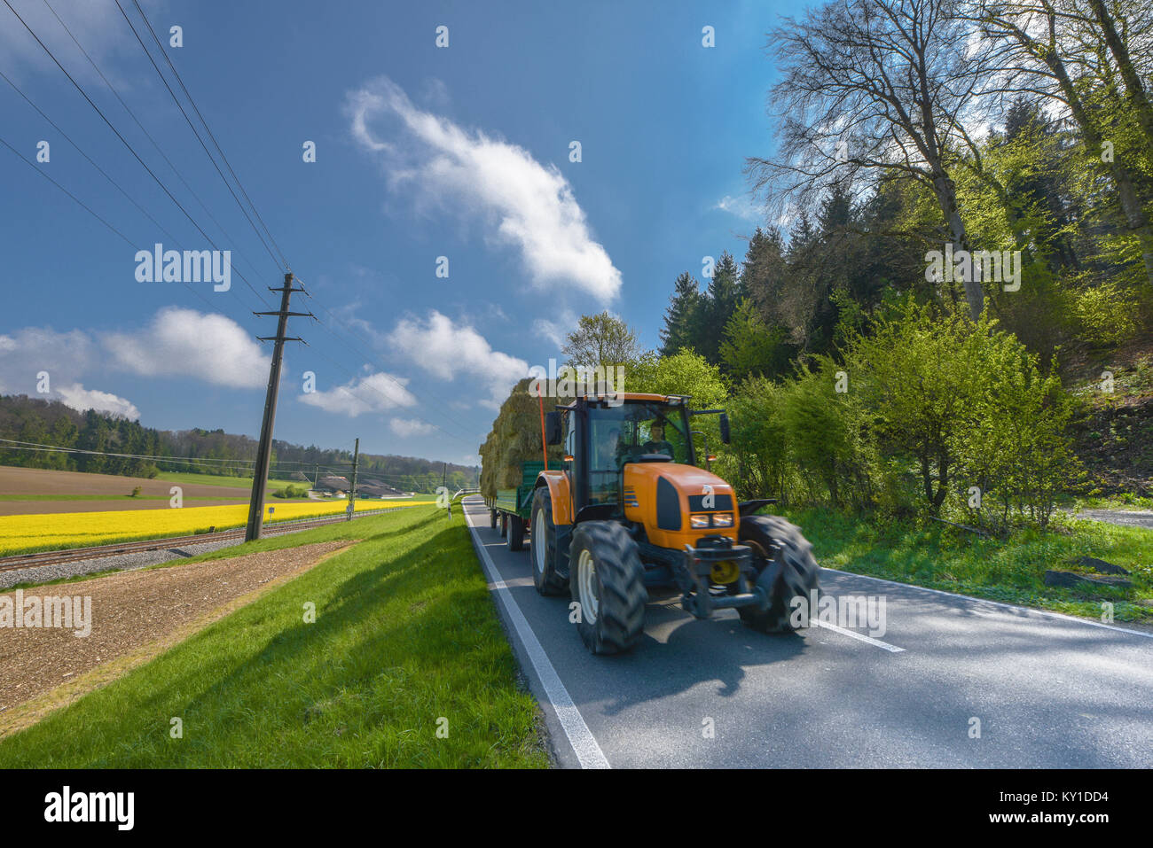 Tractor in Swiss peaceful countryside Stock Photo