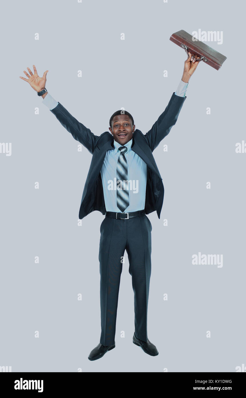 Full length of an excited handsome business man with arms raised in ...