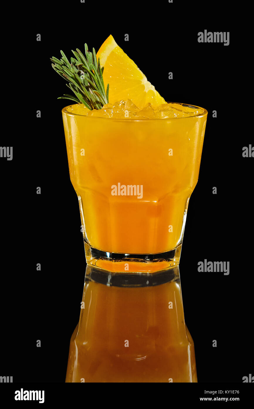 Glass with orange cocktail with reflection on blask background Stock Photo