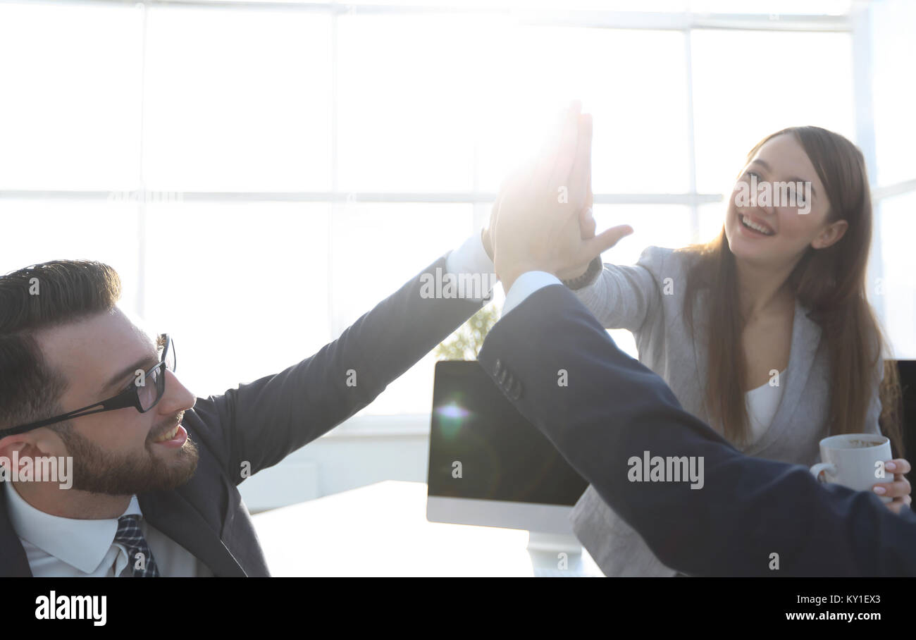 business team giving each other a high five Stock Photo - Alamy