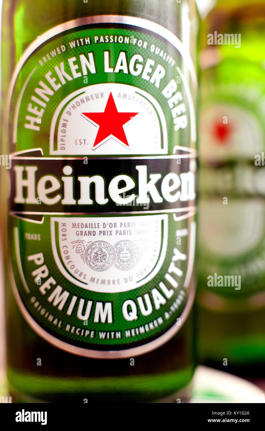 DORKOVO, BULGARIA - MARCH 13, 2017: Macro shot of Heineken bouttle over bar table, colorful club lights .Heineken Lager Beer is the flagship product o Stock Photo