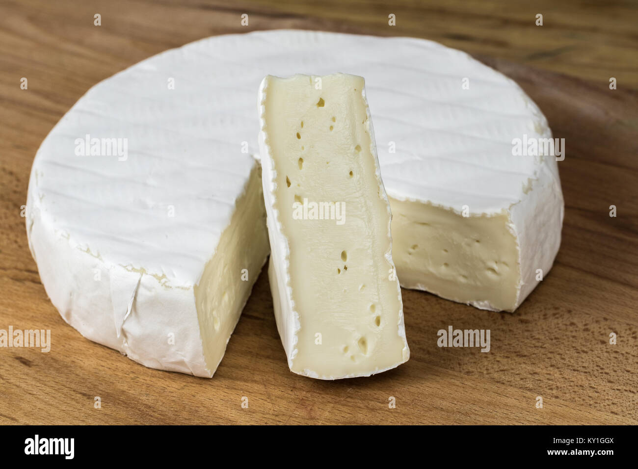 Camembert cheese brie.Triangle cutout placed vertically Stock Photo