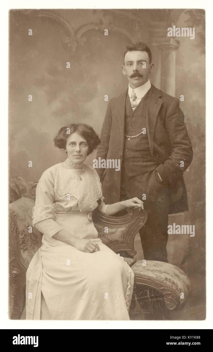 Original early 1900's studio photographic portrait of attractive Edwardian couple, the woman is wearing a high necked blouse, the man has an impressive moustache. Circa 1908, U.K. Stock Photo