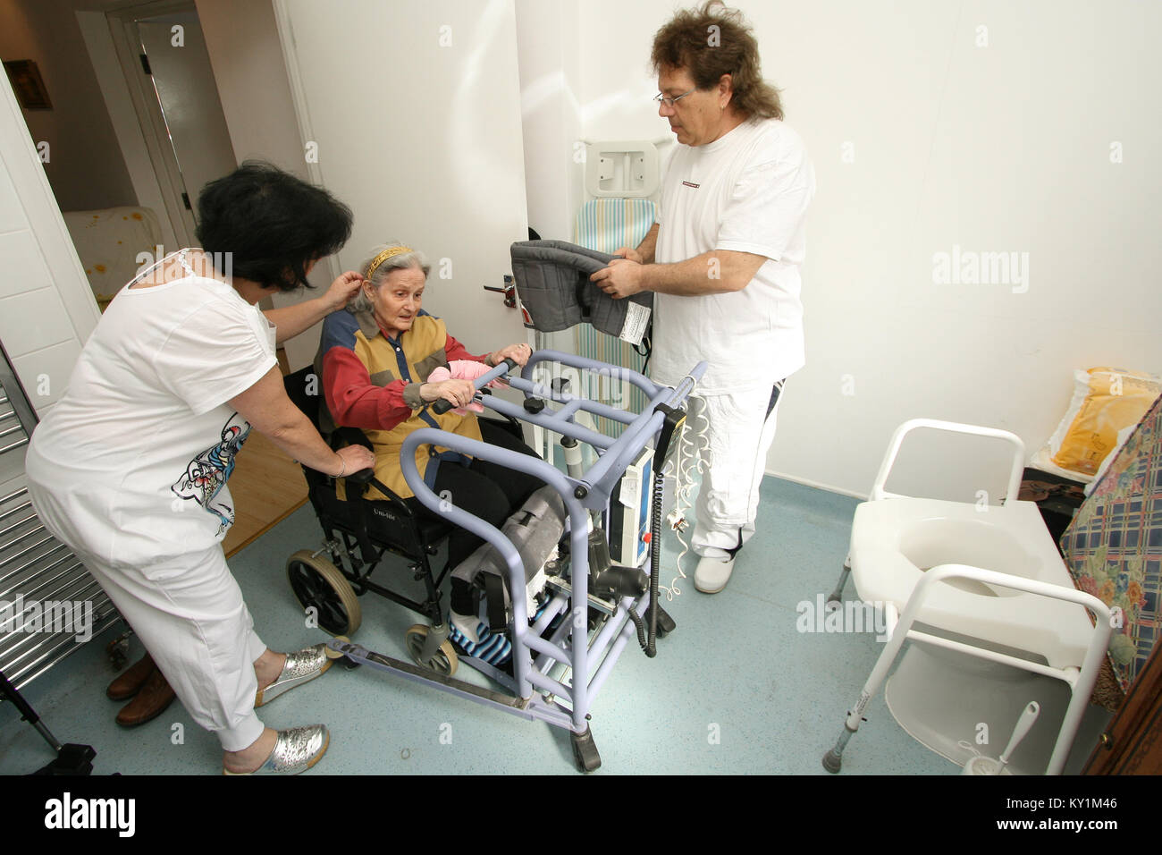 Live-in Health Care Managers give 24 hour support to elderly woman in wheelchair North London Stock Photo