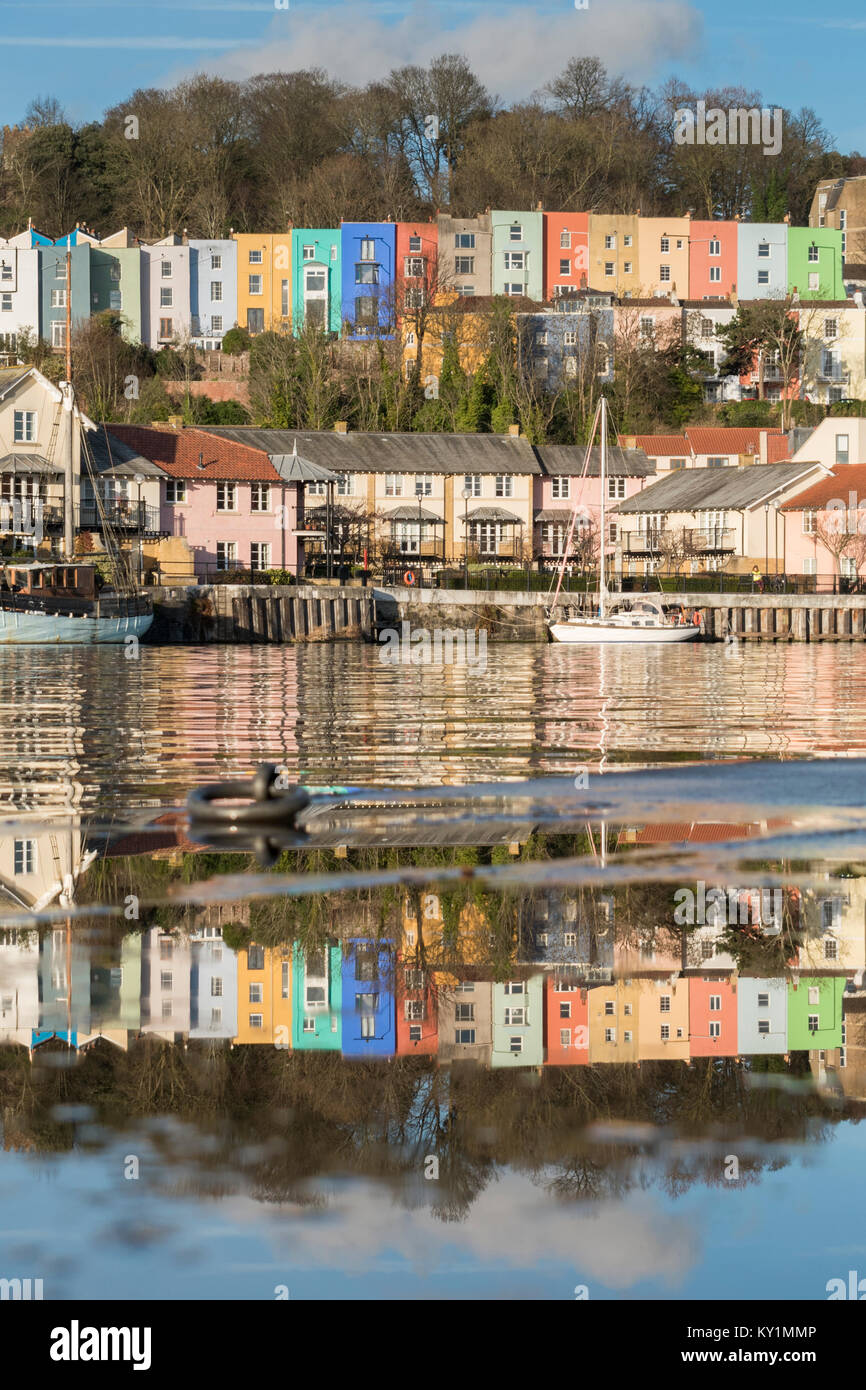 Colourful terraces of Cliftonwood in Bristol reflected in the waters of a puddle and those of the Floating Harbour, Bristol Stock Photo