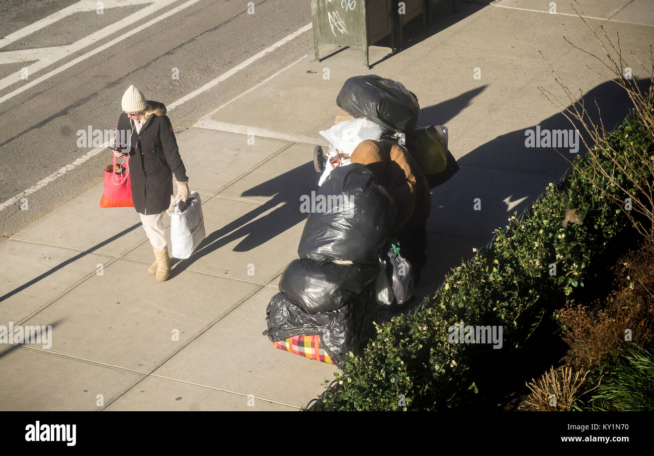A homeless man with his possessions in the Chelsea neighborhood of New York on Thursday, December 28, 2017. (© Richard B. Levine) Stock Photo