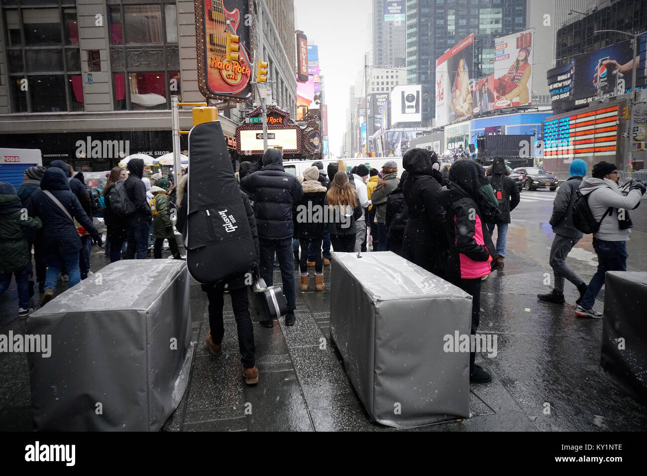 Tourists pass through barricades at the perimeter of Times Square in New York on Saturday, December 30, 2017. Security preparations are in place for New Year's eve in Times Square including the placement of rooftop observations teams and NYPD snipers. The weather for New Year's Eve is expected to be in the low teens as many stand outside for hours waiting for the Times Square Ball to drop.(© Richard B. Levine) Stock Photo