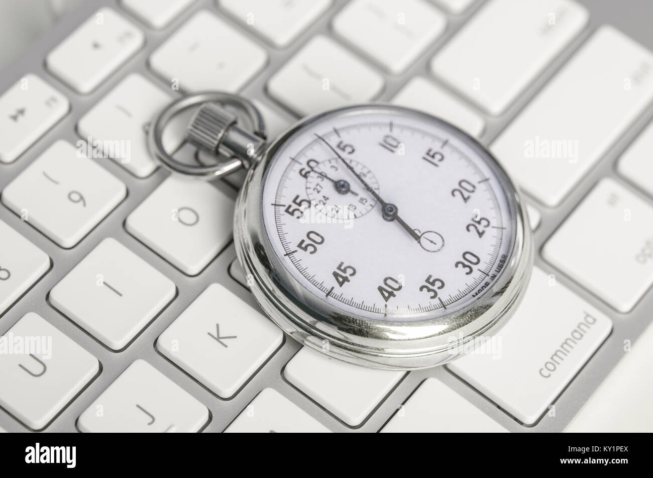 Close up of analog stopwatch on keyboard Stock Photo Alamy